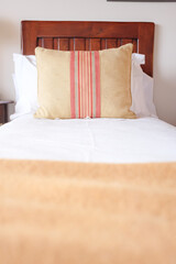 pillow with elegant design on a wooden bed