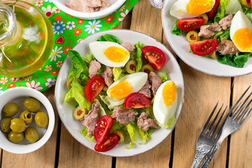 Salad with canned cod liver, tomato, olives and egg