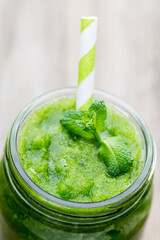 Rucola smoothie, on the grey  background.