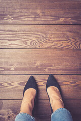 Woman in high heels standing on wooden floor