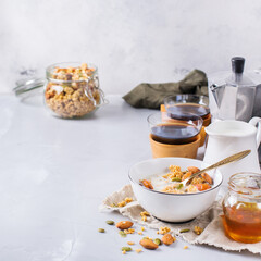 Breakfast with black coffee muesli granola honey nuts milk