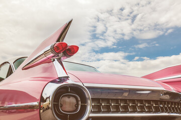 Rear end of a pink classic car