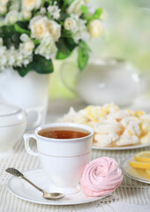 Fototapeta na wymiar Cup of tea with homemade zephyr