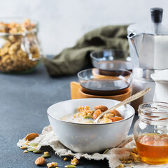 Breakfast with black coffee muesli granola honey nuts milk