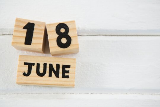 Close up of 18 june text on wooden blocks