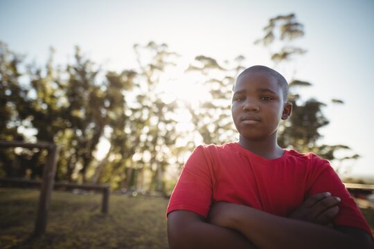 Portrait of boy standing with arms crossed