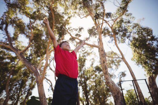 Boy cheering during obstacle course - Powered by Adobe