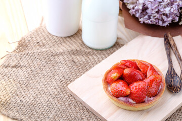 Tart with fresh strawberry on wooden background,