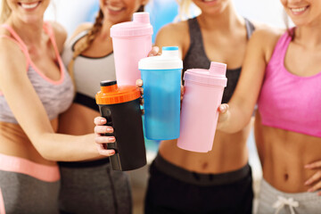 Young women group resting at the gym after workout