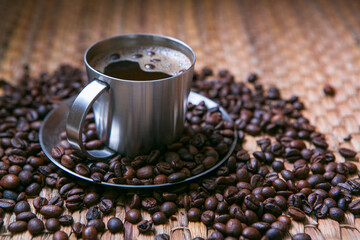 coffee cup and coffee beans on wooden table