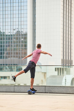 Man on hoverboard, flying pose. Person on urban background.