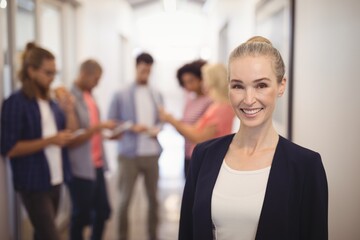 Portrait of smiling businesswoman standing 