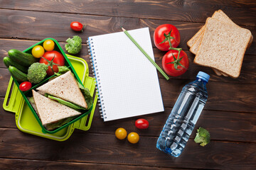 Naklejka na ściany i meble Lunch box with vegetables and sandwich