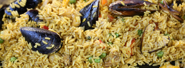 Spanish paella with mussels and tasty yellow rice and seafood