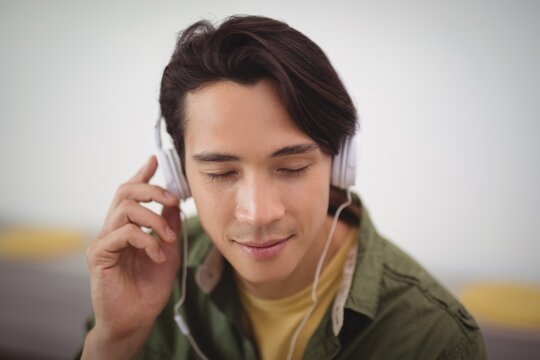Businessman listening music with headphones 