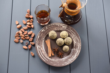 Homemade chocolate candies with pour over coffee and raw cocoa beans