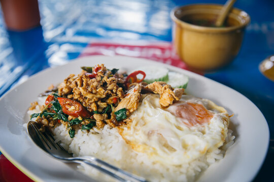 Thai simple meal. Street food in Thailand jasmine rice with stir-fried of chicken and basil leaf with fried egg hot and spicy dish.
