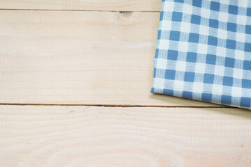 Blue and white napkin on wooden of brown