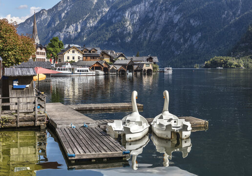 Boats in the form of swans on lake Hallstatt in beautiful alpine village Hallstatt