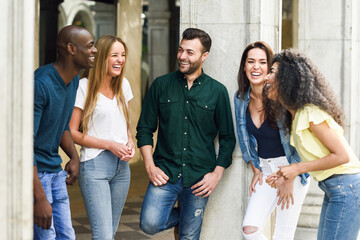 Obraz na płótnie Canvas Multi-ethnic group of friends having fun together in urban background