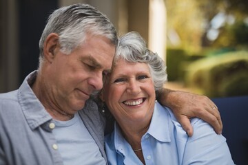 Portrait of smiling senior woman embracing man