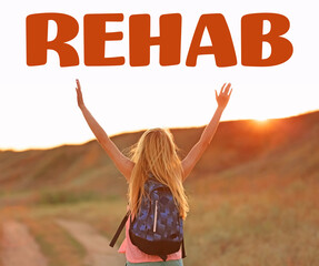 Young woman with raising hands on blue sky background