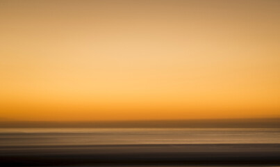 Blurred orange sunset at beach 