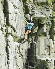 Fototapeta premium A young man climbs in a canyon.