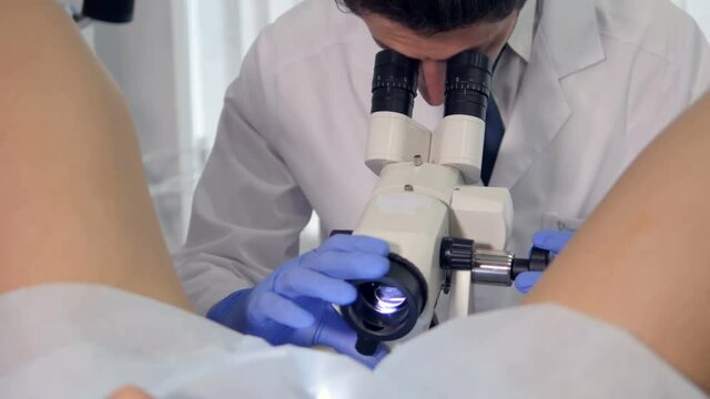 A young gynecologist is giving a medical treatment to a girl. 4K.