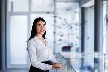 Modern business woman smiling at office