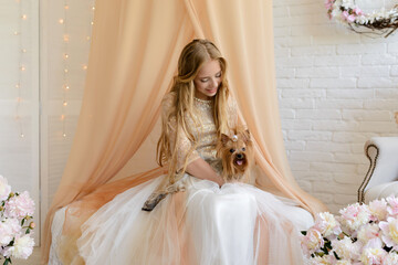 Beautiful girl in a studio. She wear light beautiful dress