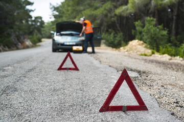 Repairman near broken down car
