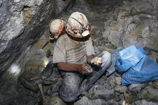 Potosi, Bolivia - November 29, 2013: Two miners looking for silver in the silver mine of the Cerro Rico in Potosi, Bolivia.