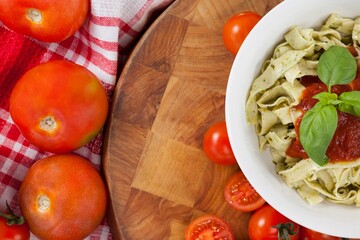 Fettuccine pasta with tomatoes, garlic and napkin cloth