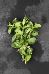 Obraz na płótnie Canvas Bunch fresh mints on a dark background. Top view. Food background