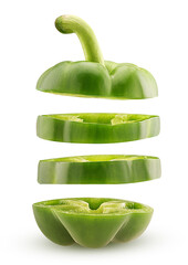 Slices green bell pepper flying in the air