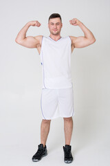 Fototapeta na wymiar Man in sports uniform shows biceps