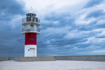 Fototapeta na wymiar View of small Lighthouse Against Storm Clouds