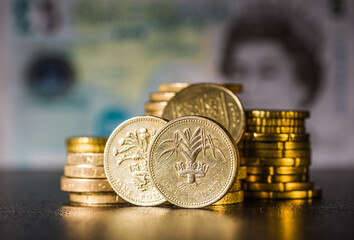 British coins stack on black, pound sterling