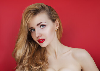 Young beautiful woman on a red background