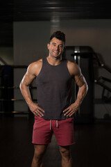 Fototapeta na wymiar Man In Undershirt Flexing Muscles