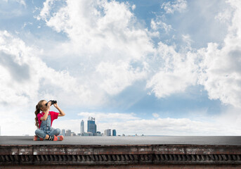 Naklejka premium Concept of careless happy childhood with girl of school age looking in future