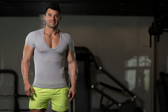 Strong Man in Grey T-shirt Background Gym