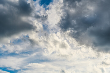 Fototapeta na wymiar Bright contrasting gray clouds in the blue sky