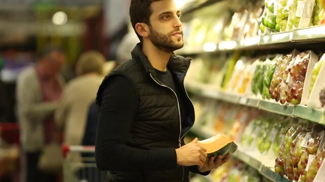 Young Man Shopping at Supermarket