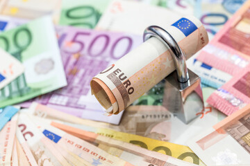 money security concept - euro banknote and padlock