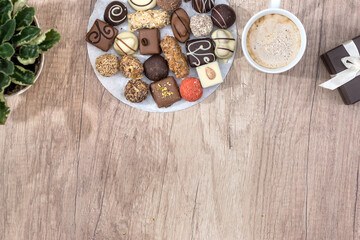 many delicious sweets with cup of cappuccino on the table.
