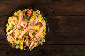 Spanish seafood paella in paellera with copyspace