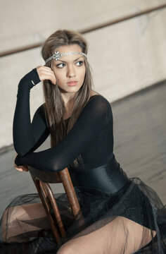 Contemporary ballet dancer on a wooden chair on a repetition