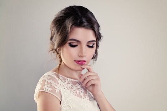 Cute Young Woman Fiancee with Perfect Bridal Hairstyle, Event Makeup and White Dress